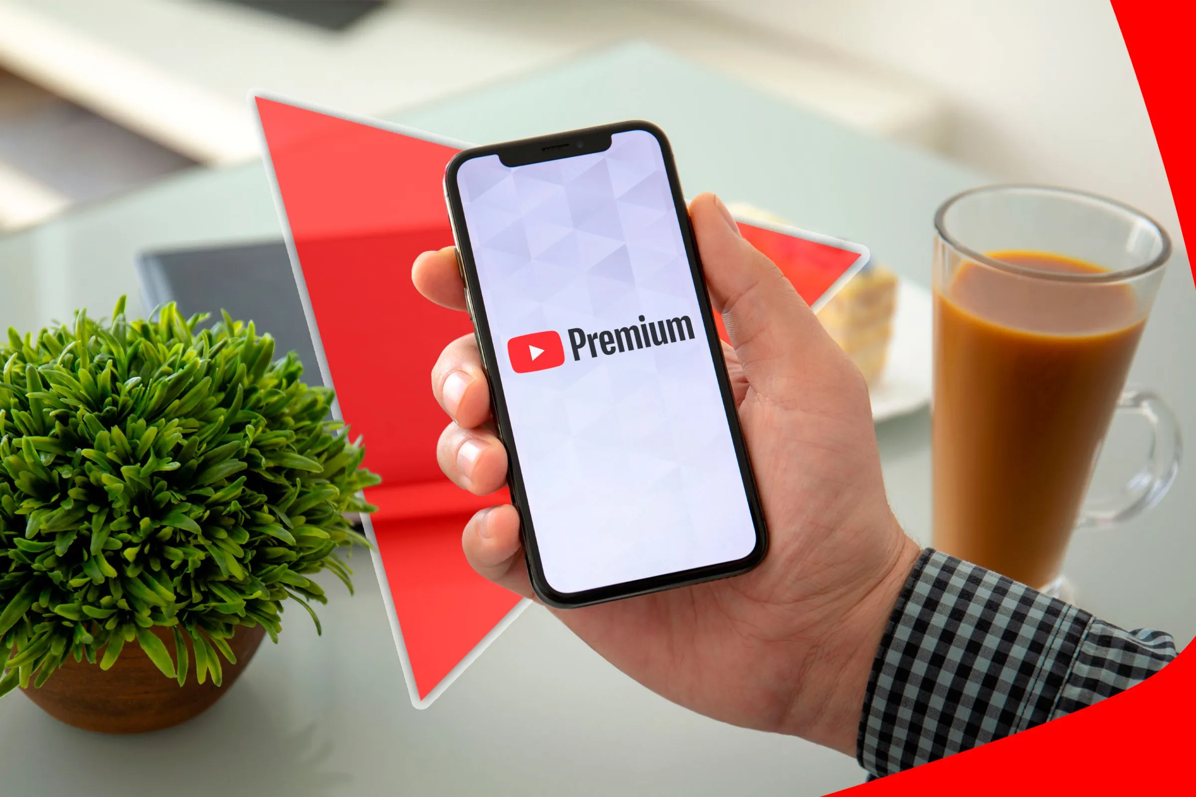 Bàn tay cầm điện thoại hiển thị logo YouTube Premium, liên quan đến sự cố lịch sử xem YouTube trên Pi-hole