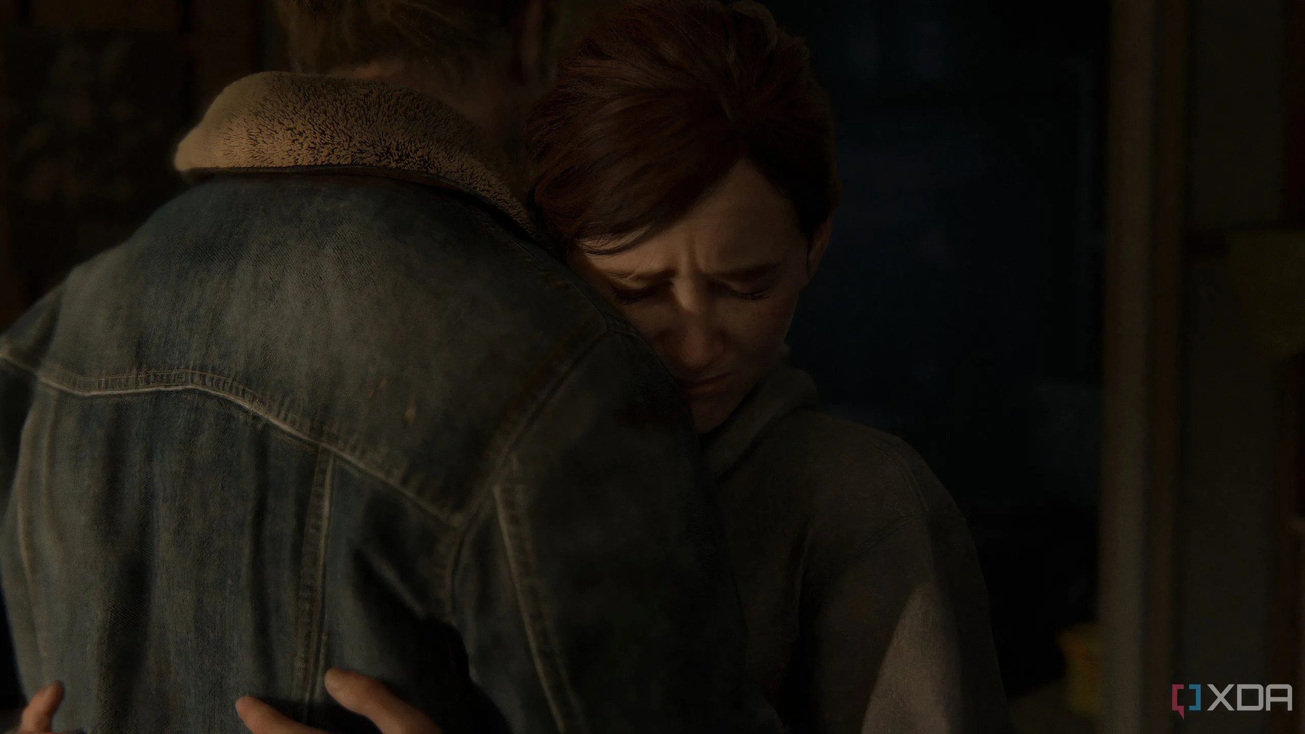 A screenshot from the game The Last of Us Part II Remastered on PC, showing Ellie hugging Tommy.