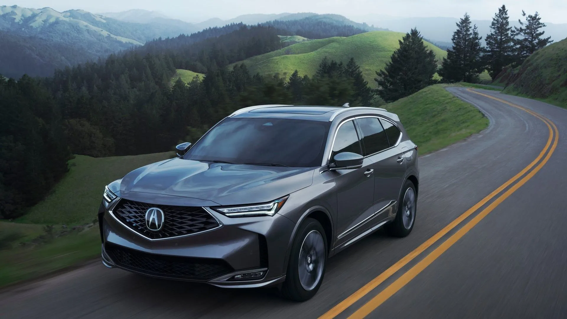 Acura MDX 2025 màu xanh ngọc di chuyển trên đường, mẫu SUV hạng sang cỡ trung có độ tin cậy cao.