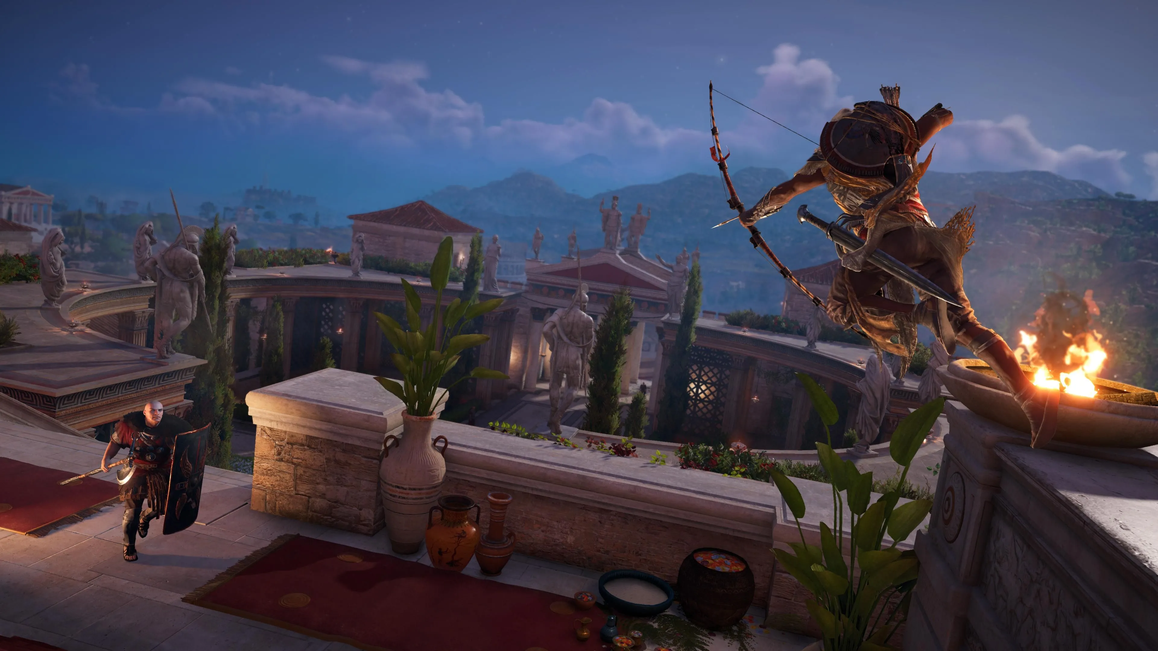 Bayek nhảy từ vách đá và nhắm cung vào lính với khiên trong Assassin's Creed Origins