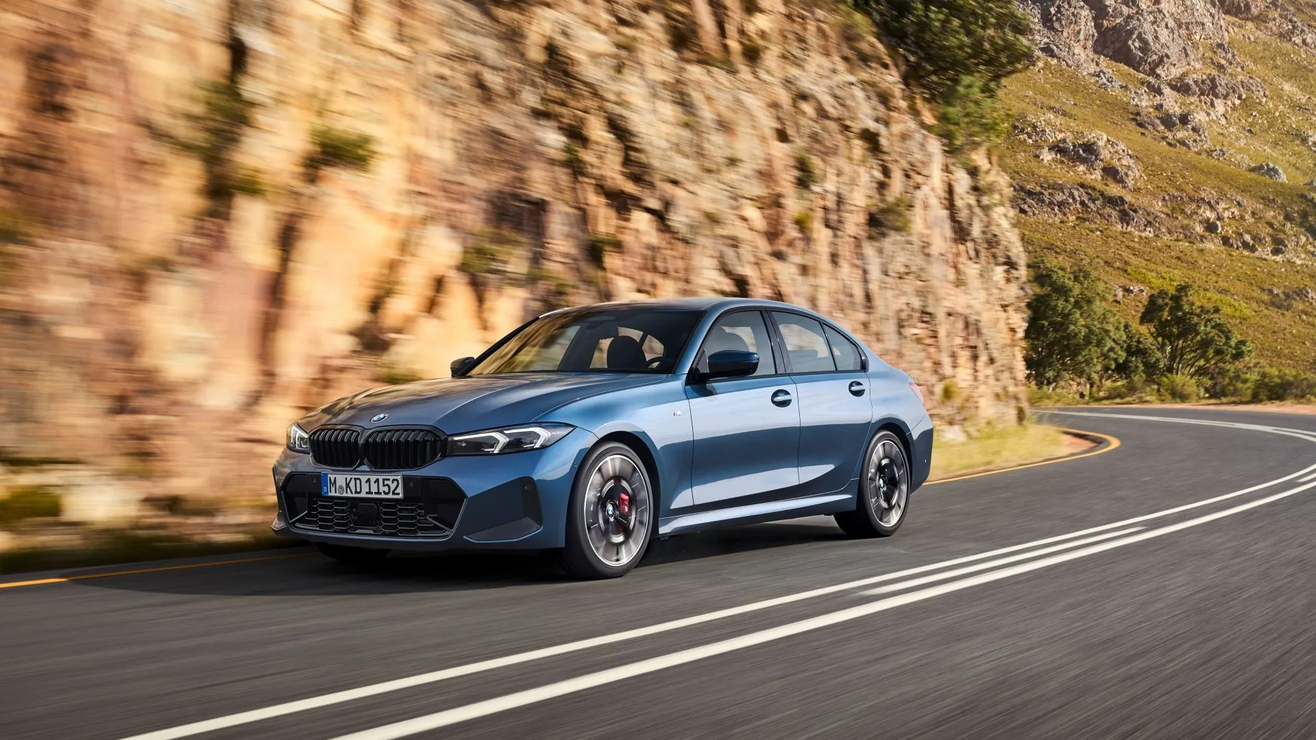 BMW 330i 2025 màu xám, góc 3/4 phía trước, đang di chuyển nhanh