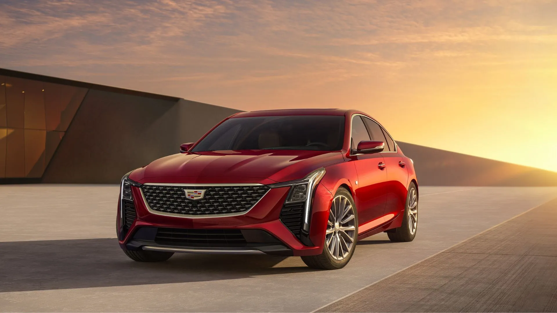 Cadillac CT5 2025 màu đỏ với khung cảnh hoàng hôn, sedan hạng sang bền bỉ của Mỹ.