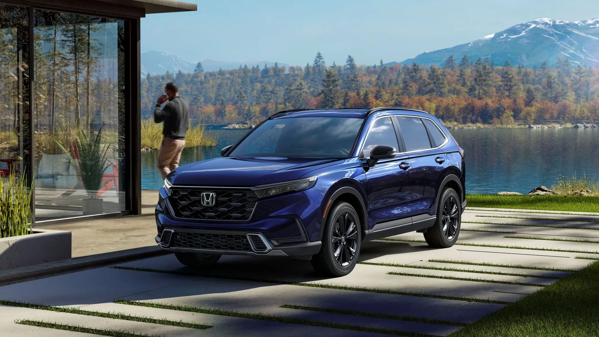Hình ảnh mặt trước ba phần tư của một chiếc Honda CR-V Sport Touring 2023 màu xanh đậm đang đậu ngoài trời.