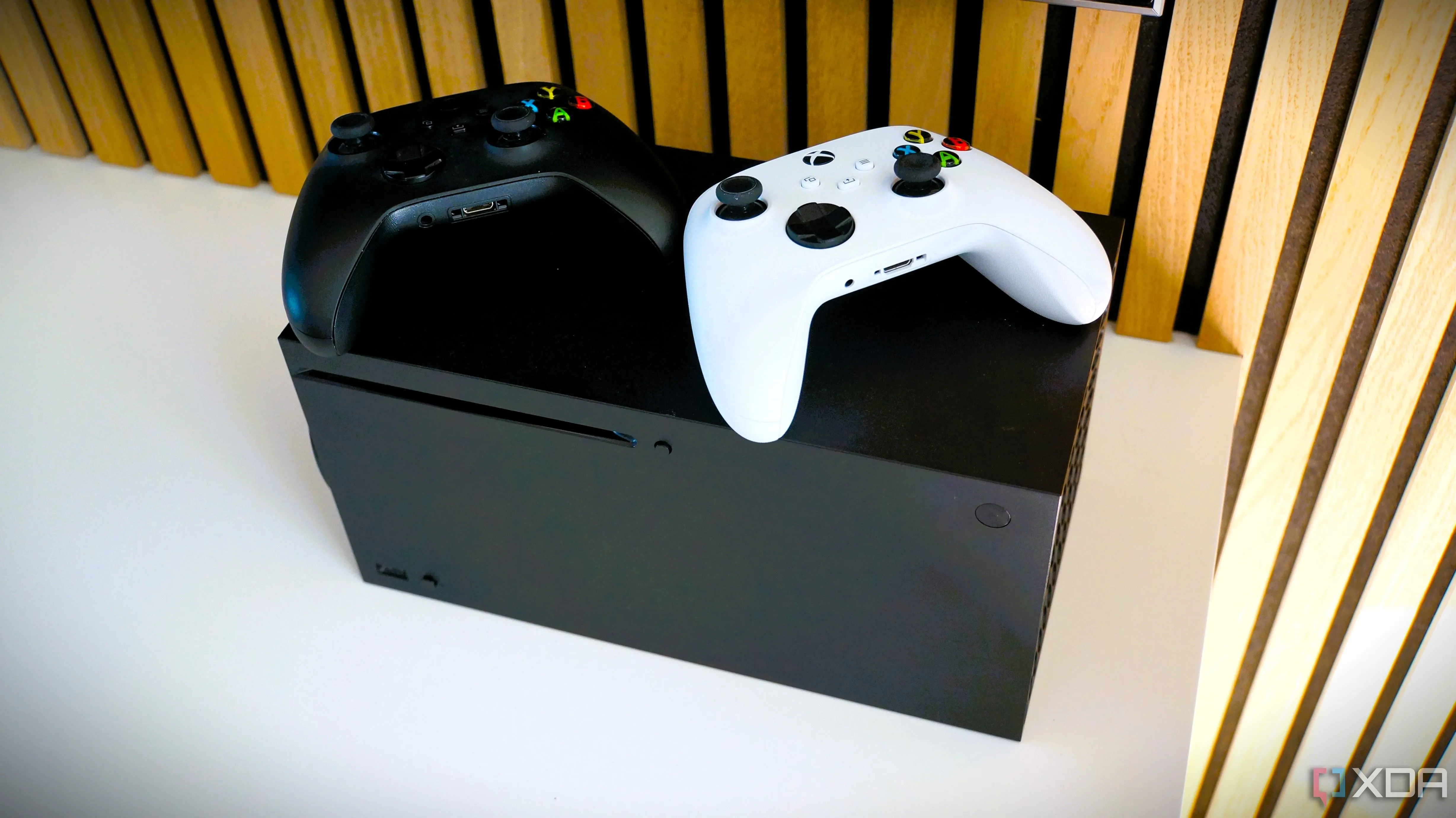 Máy chơi game Xbox Series X với tay cầm đen và trắng, nền tảng cũng có lịch sử tương thích ngược ấn tượng.