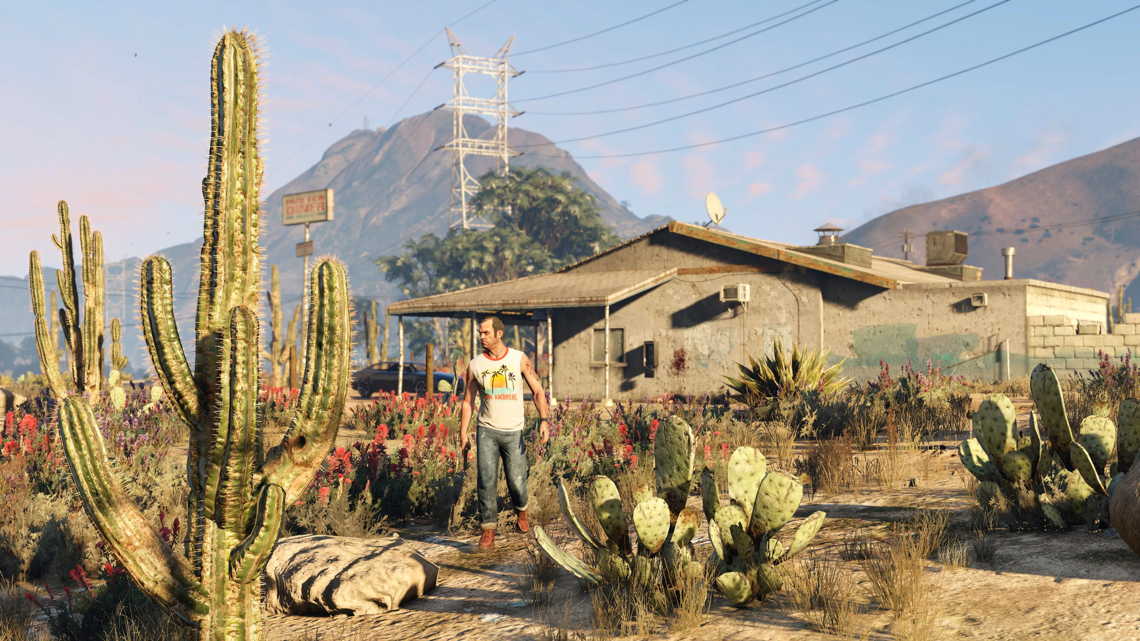 Nhân vật Trevor trong Grand Theft Auto 5 đứng trước một ngôi nhà ở Blaine County